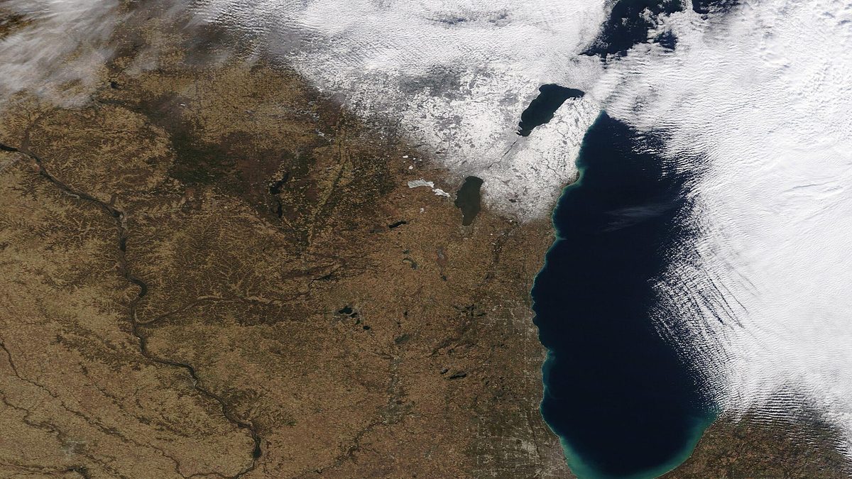 True-color satellite image of Lake Michigan showing snow-filled cloud over the eastern shore near Michigan while the western, Chicago-side shore stays clear