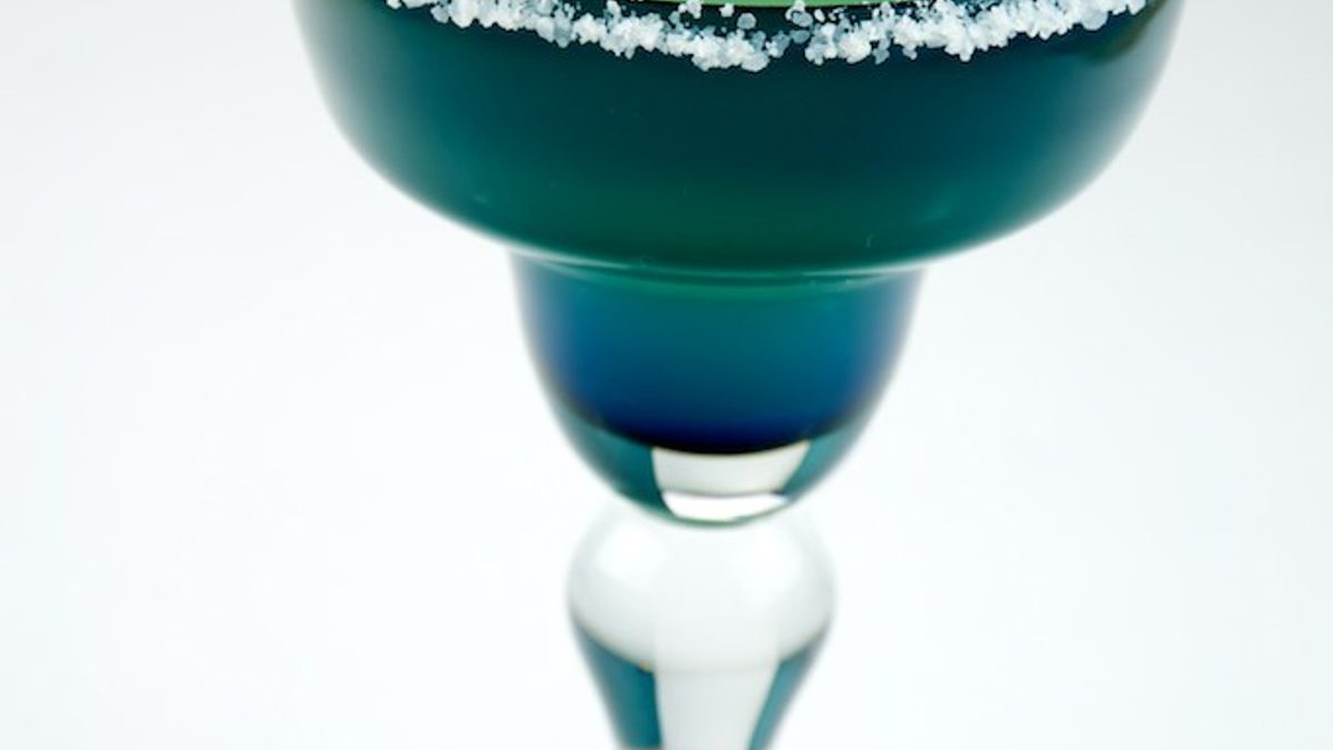 A margarita cocktail with a lime wedge and a salted rim