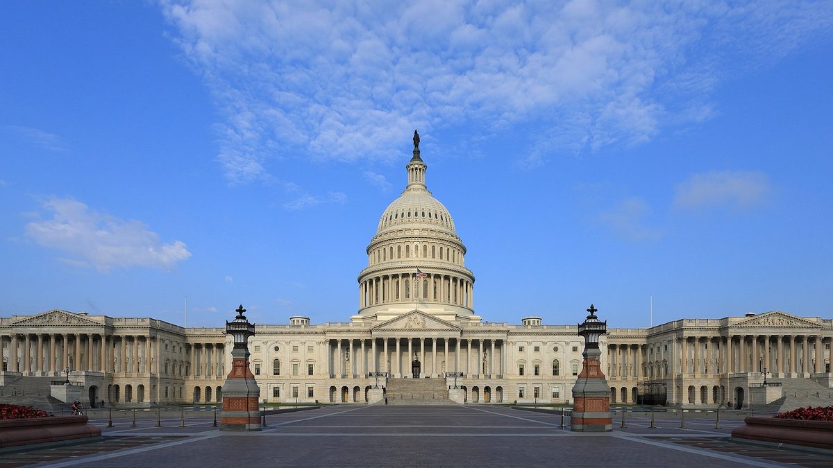 The east front of the United States Capitol building under a clear blue sky, where Congress sets every federal funding deadline